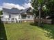 Spacious backyard with green lawn, wooden fence, and a white house with a deck, great for entertaining at 212 W Church St, Benson, NC 27504