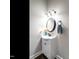 Half-bath with modern vanity, fixtures, and a decorative mirror at 212 W Church St, Benson, NC 27504