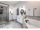 Bright bathroom featuring a glass-enclosed shower, soaking tub, and double vanities with modern fixtures at 212 W Church St, Benson, NC 27504