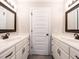 Bathroom with double vanities, marble countertops, and dark hardware at 212 W Church St, Benson, NC 27504