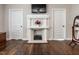 Bedroom with decorative fireplace and hardwood floors at 212 W Church St, Benson, NC 27504