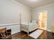 Cozy bedroom with dark hardwood floors, a four-poster bed, and an ensuite bathroom at 212 W Church St, Benson, NC 27504