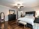 Spacious bedroom with hardwood floors, ceiling fan, and closet at 212 W Church St, Benson, NC 27504