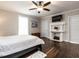 Relaxing bedroom featuring a decorative fireplace, hardwood floors and natural light at 212 W Church St, Benson, NC 27504
