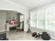 Sunlit bonus room featuring a rowing machine, desk, and mannequin, creating a versatile space at 212 W Church St, Benson, NC 27504