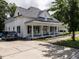 Well-maintained house boasts a covered front porch and a long driveway for ample parking at 212 W Church St, Benson, NC 27504