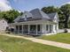 Beautiful two-story home with a spacious wraparound porch, perfect for enjoying the outdoors at 212 W Church St, Benson, NC 27504