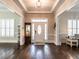 Elegant foyer with hardwood floors, decorative mirror, and access to adjoining living spaces at 212 W Church St, Benson, NC 27504
