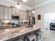Updated kitchen with gray cabinets, granite countertops, stainless appliances, and a breakfast bar at 212 W Church St, Benson, NC 27504