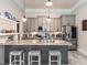 Kitchen island with gray cabinets, granite countertops, and seating at 212 W Church St, Benson, NC 27504