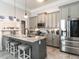 Spacious kitchen with gray cabinets, granite countertops, island seating and stainless steel appliances at 212 W Church St, Benson, NC 27504