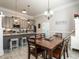 Kitchen and dining area featuring gray cabinets, granite countertops, and stainless steel appliances at 212 W Church St, Benson, NC 27504