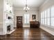 Elegant living room featuring a fireplace, dark wood floors, and bright windows with plantation shutters at 212 W Church St, Benson, NC 27504