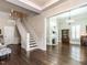 Open living area with staircase, fireplace and large windows at 212 W Church St, Benson, NC 27504