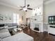 Cozy living room with elegant fireplace, ceiling fan, and hardwood flooring at 212 W Church St, Benson, NC 27504