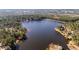 Aerial view of the neighborhood lake, showcasing waterfront homes and lush greenery at 216 Captain Harbor Hbr, Sanford, NC 27332