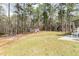 Large backyard area with many pine trees, a playground, and plenty of space for entertaining at 216 Captain Harbor Hbr, Sanford, NC 27332