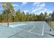 Community basketball court surrounded by mature trees, fenced in, for friendly games at 216 Captain Harbor Hbr, Sanford, NC 27332