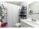 Bathroom features a single sink, toilet, shower with curtain and storage shelf at 216 Captain Harbor Hbr, Sanford, NC 27332
