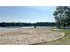 Community beach on the lake with a volleyball net and sandy shore at 216 Captain Harbor Hbr, Sanford, NC 27332