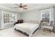 Bright bedroom with a ceiling fan, comfy armchair, large window, and glass desk at 216 Captain Harbor Hbr, Sanford, NC 27332