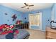 Blue-themed bedroom with superhero decor, a ceiling fan, and a window at 216 Captain Harbor Hbr, Sanford, NC 27332