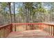 Outdoor deck overlooking a wooded area with an outdoor play set; great view and ideal for relaxation at 216 Captain Harbor Hbr, Sanford, NC 27332