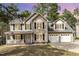 Charming two-story home featuring a covered front porch and a two-car garage at 216 Captain Harbor Hbr, Sanford, NC 27332