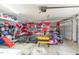 Spacious garage with a custom painted wall, work out equipment, storage, and visible garage door at 216 Captain Harbor Hbr, Sanford, NC 27332