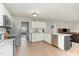 Bright kitchen with stainless steel appliances, white cabinets, and an adjacent dining area at 216 Captain Harbor Hbr, Sanford, NC 27332