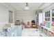 Bright playroom features a tray ceiling, light gray walls and an assortment of colorful toys and shelving at 216 Captain Harbor Hbr, Sanford, NC 27332