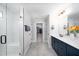 Well-lit bathroom with double vanity, walk-in shower, and a glimpse into the walk-in closet at 226 Castle Pond Way, Fuquay Varina, NC 27526