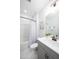 Modern bathroom with white tile, gray vanity, neutral decor, and shower with glass doors at 226 Castle Pond Way, Fuquay Varina, NC 27526