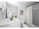 Well-lit bathroom with a white vanity, framed mirror, and shower-tub combo, offering a fresh, clean aesthetic at 226 Castle Pond Way, Fuquay Varina, NC 27526