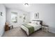 Bright bedroom featuring neutral colored walls, carpet, natural light from backyard, and simple decor at 226 Castle Pond Way, Fuquay Varina, NC 27526