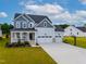 Stunning two-story home with a welcoming front porch, three-car garage, and a basketball court at 226 Castle Pond Way, Fuquay Varina, NC 27526