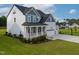 Beautiful two-story home featuring a covered front porch, a spacious three-car garage, and lush landscaping at 226 Castle Pond Way, Fuquay Varina, NC 27526