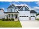 Charming two-story home with a welcoming front porch, three-car garage, and well-manicured lawn at 226 Castle Pond Way, Fuquay Varina, NC 27526