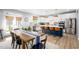 Modern kitchen with stainless steel appliances, a large island, and an adjacent dining area at 226 Castle Pond Way, Fuquay Varina, NC 27526