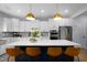 Kitchen island featuring seating, pendant lighting, stainless appliances and white countertops at 226 Castle Pond Way, Fuquay Varina, NC 27526
