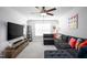 Comfortable living room with a large sectional sofa, entertainment center, and cozy decor, perfect for Gathering gatherings at 226 Castle Pond Way, Fuquay Varina, NC 27526