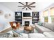 Cozy living room with a fireplace, built-in shelving, and comfortable seating arrangement at 226 Castle Pond Way, Fuquay Varina, NC 27526