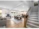 Open-concept living space with dining area, kitchen, staircase, and hardwood floors at 226 Castle Pond Way, Fuquay Varina, NC 27526