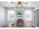 Bright home office featuring a large desk, natural light, and modern fixtures, creating a productive space at 226 Castle Pond Way, Fuquay Varina, NC 27526