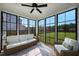 Sunroom with ample natural light, ceiling fan, light colored wicker furniture and views to backyard at 226 Castle Pond Way, Fuquay Varina, NC 27526