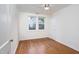 Empty bedroom with hardwood floors and double-paned windows at 2523 Glendale Ave, Durham, NC 27704