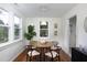 A stylish dining area features a round table, modern décor, and hardwood floors at 2523 Glendale Ave, Durham, NC 27704