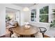 Bright dining area features a round table, modern lighting, and large windows overlooking the outdoors at 2523 Glendale Ave, Durham, NC 27704