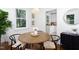 Bright dining area with a round table, modern light fixture, and hardwood flooring at 2523 Glendale Ave, Durham, NC 27704