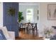 Dining room with modern lighting and hardwood floors seen through doorway at 2523 Glendale Ave, Durham, NC 27704